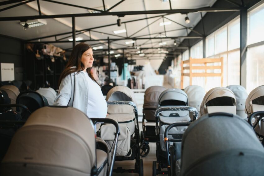 pregnant woman shopping for a stroller